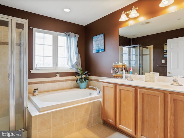 full bath with a garden tub, double vanity, a sink, a shower stall, and tile patterned floors