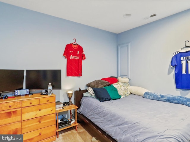 carpeted bedroom featuring visible vents