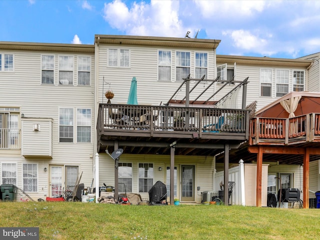 back of house featuring central AC, a lawn, and a wooden deck