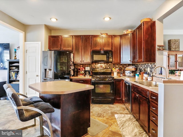 kitchen featuring black appliances, a sink, light countertops, and decorative backsplash