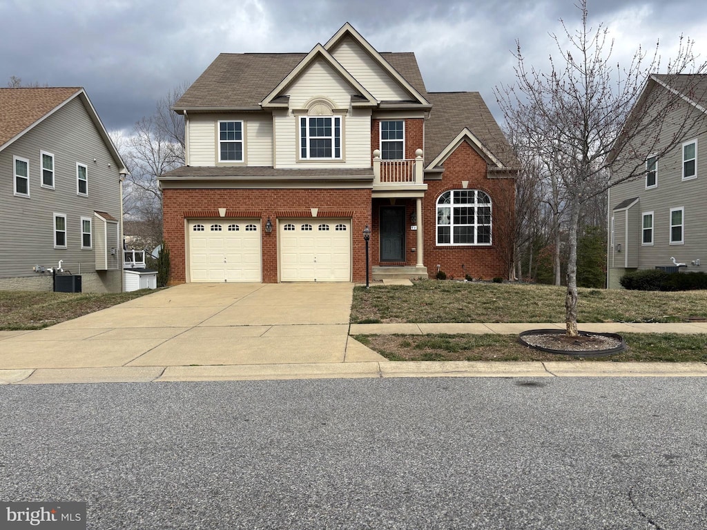 traditional home featuring cooling unit, concrete driveway, an attached garage, a shingled roof, and brick siding