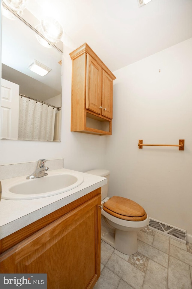 full bath with tile patterned flooring, visible vents, vanity, and toilet