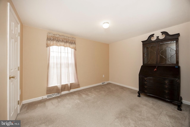 carpeted bedroom with visible vents and baseboards