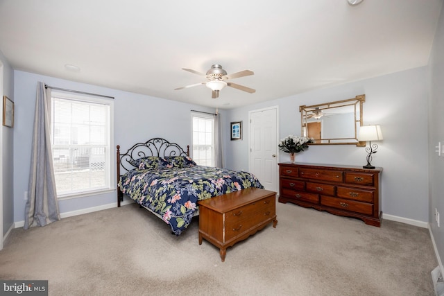 carpeted bedroom with ceiling fan and baseboards