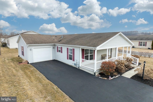 ranch-style home with aphalt driveway, a shingled roof, covered porch, a garage, and a front lawn