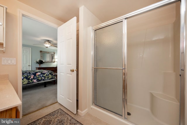 bathroom featuring a stall shower, tile patterned flooring, vanity, and ensuite bathroom