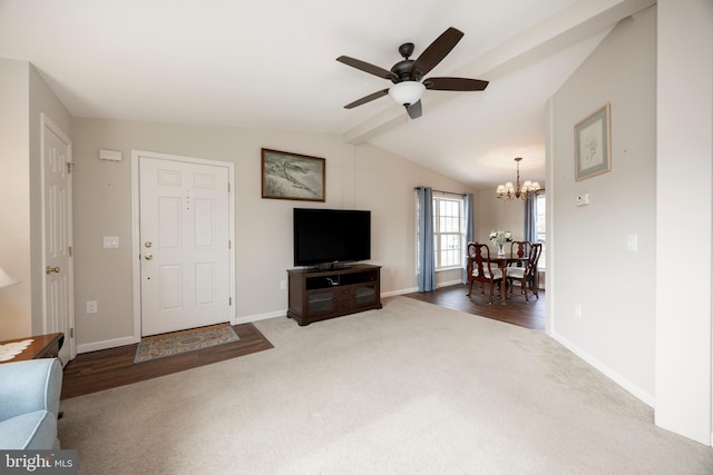 unfurnished living room with carpet floors, lofted ceiling with beams, baseboards, and ceiling fan with notable chandelier