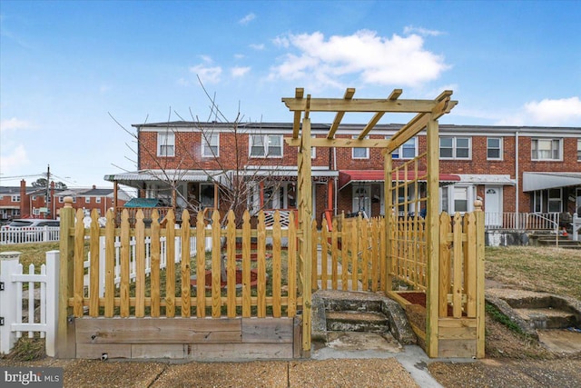 view of front of house with a fenced front yard and brick siding