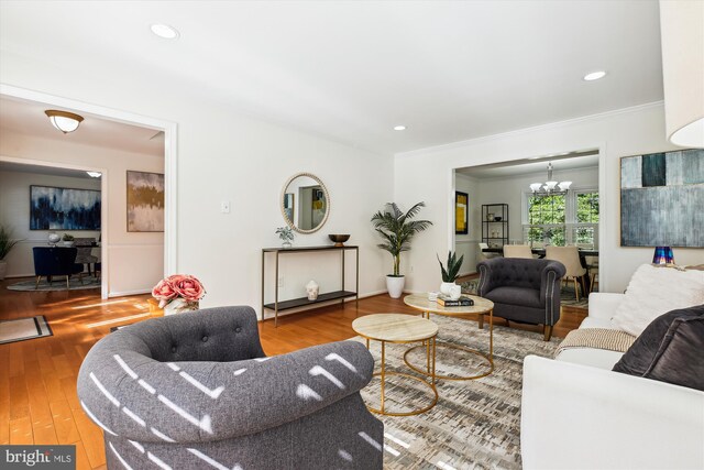 1729 Hutchinson Ln, Silver Spring, MD 20906 - living room featuring a chandelier, wood finished floors, ornamental molding, and recessed lighting