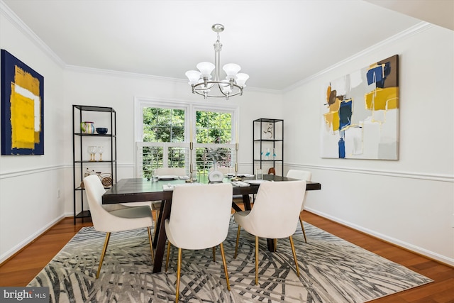 1729 Hutchinson Ln, Silver Spring, MD 20906 - dining space with a chandelier, wood finished floors, crown molding, and baseboards