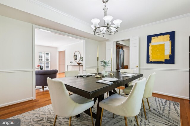 1729 Hutchinson Ln, Silver Spring, MD 20906 - dining area featuring a chandelier, light wood-style floors, crown molding, and baseboards