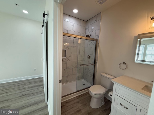 full bath featuring a stall shower, visible vents, toilet, and wood finished floors