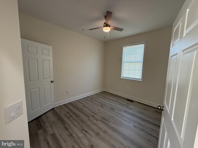 unfurnished bedroom with visible vents, baseboards, wood finished floors, and a ceiling fan