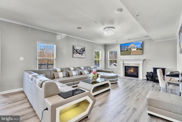 living room featuring plenty of natural light, ornamental molding, and wood finished floors