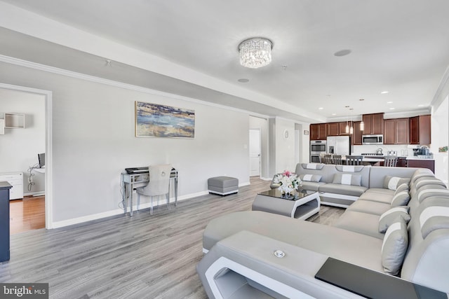 living area with light wood-style flooring, recessed lighting, baseboards, and ornamental molding