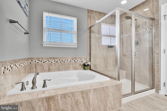 full bath featuring a garden tub and a stall shower