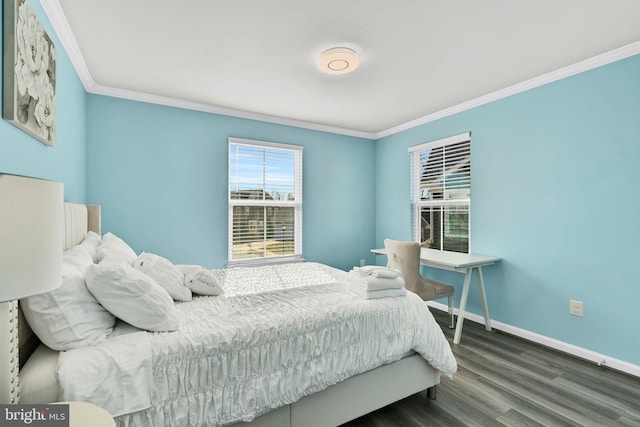 bedroom with baseboards, wood finished floors, and crown molding