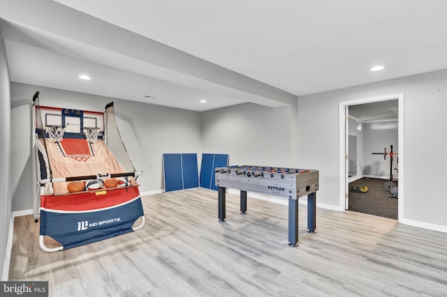 recreation room with recessed lighting, wood finished floors, and baseboards