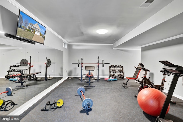 exercise room featuring visible vents, baseboards, and ornamental molding