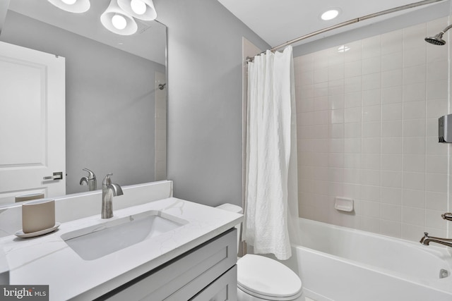 bathroom featuring toilet, shower / bath combo, and vanity