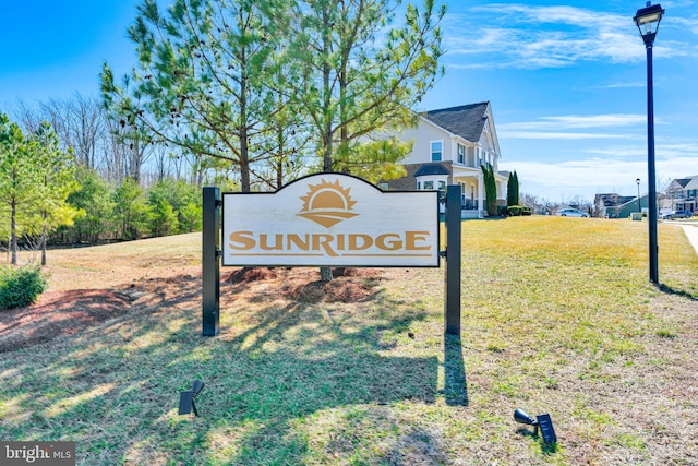 community / neighborhood sign featuring a lawn