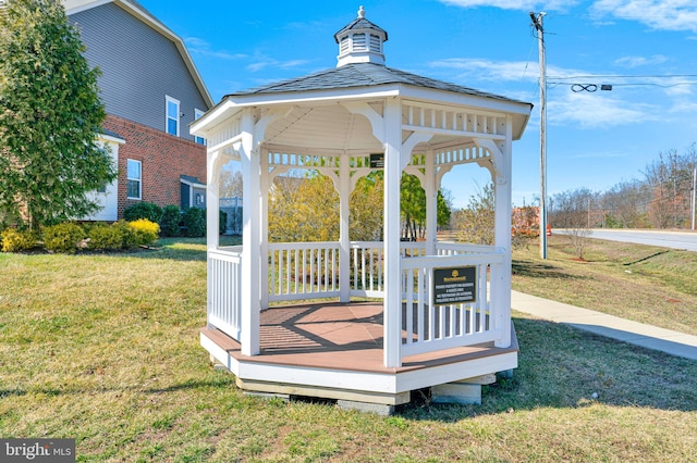 wooden terrace featuring a gazebo and a yard