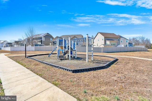 community playground with fence and a residential view