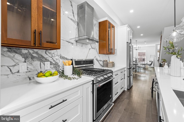 kitchen with stainless steel appliances, brown cabinets, glass insert cabinets, and wall chimney range hood