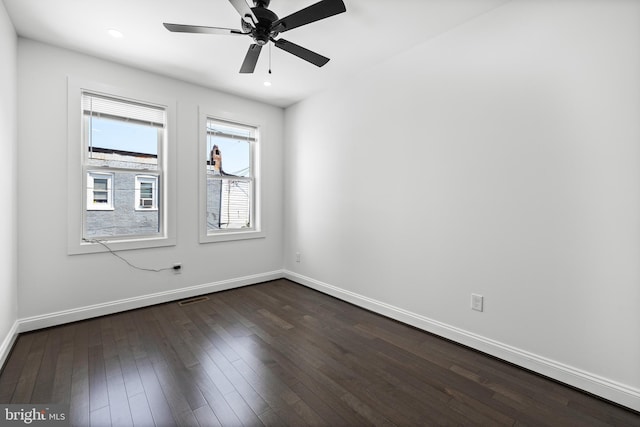 unfurnished room with dark wood-type flooring, recessed lighting, visible vents, and baseboards