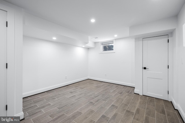 below grade area with baseboards, wood finish floors, and recessed lighting