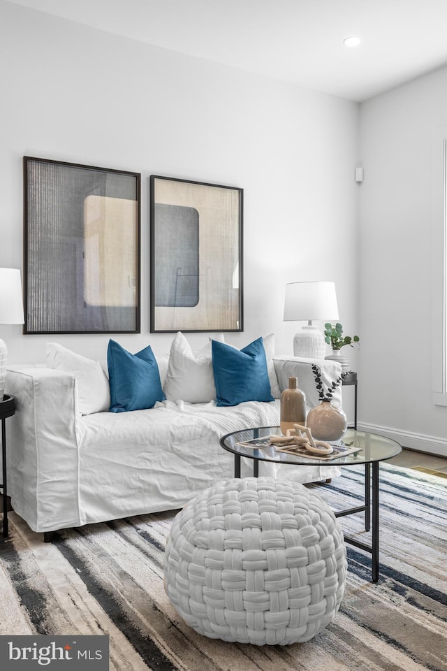 living area with recessed lighting, wood finished floors, and baseboards