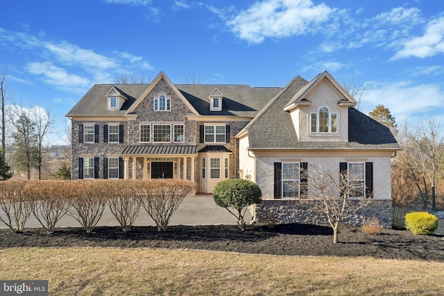 view of front of home with stone siding and a shingled roof