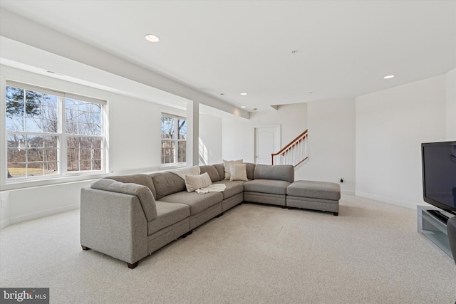 living area with recessed lighting, baseboards, and light colored carpet