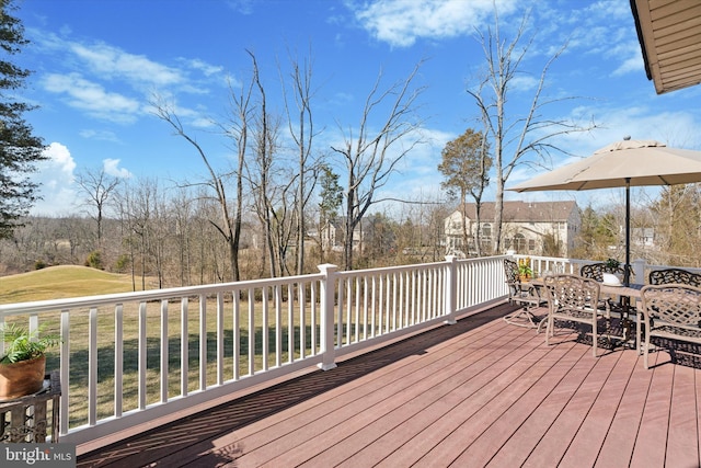 wooden terrace featuring outdoor dining area