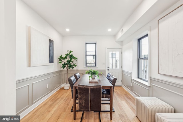 dining space featuring visible vents, wainscoting, light wood-style flooring, and recessed lighting