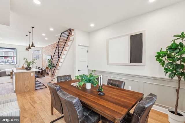 dining room with stairway, wainscoting, light wood-style flooring, and recessed lighting