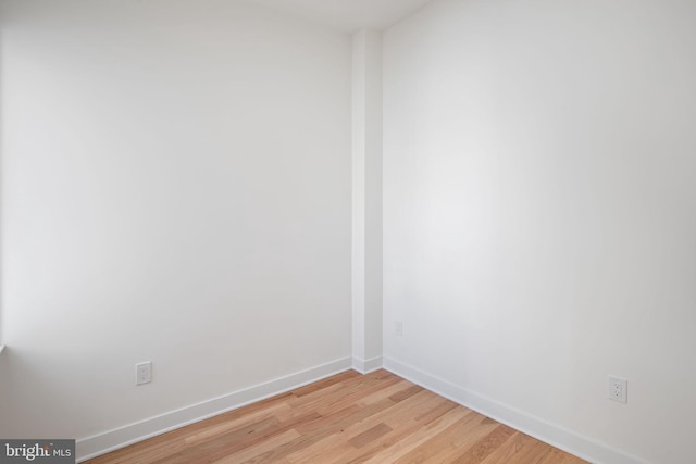 spare room with light wood finished floors and baseboards