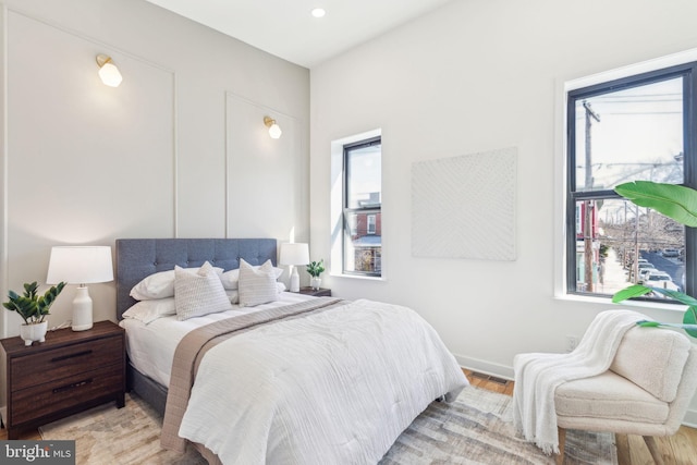 bedroom featuring light wood-style floors, baseboards, visible vents, and recessed lighting