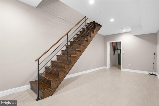 staircase with baseboards and recessed lighting