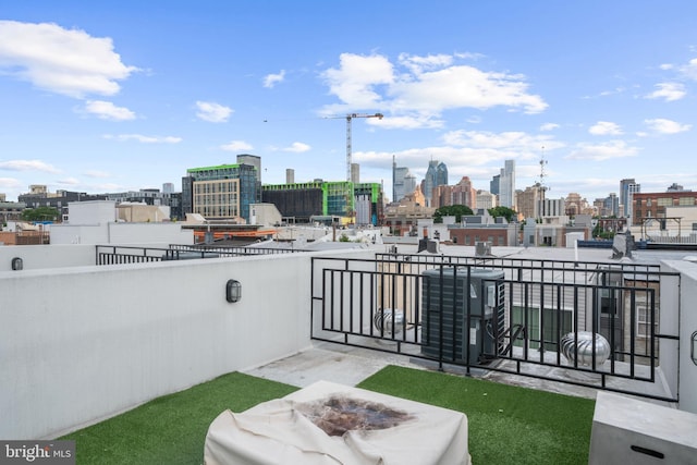 view of patio featuring a view of city, a fire pit, and cooling unit