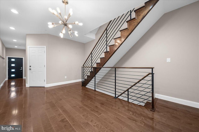 foyer featuring baseboards, recessed lighting, wood finished floors, and an inviting chandelier