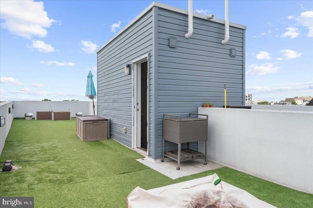 rear view of house featuring a yard