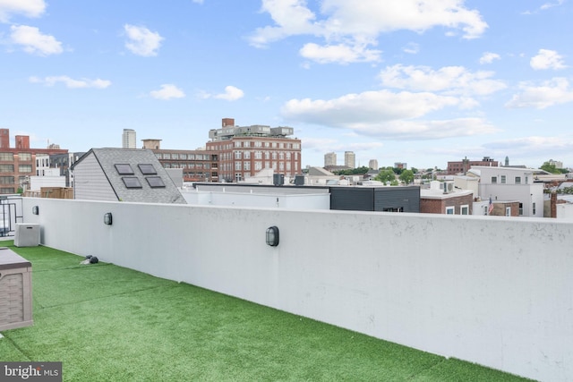 view of yard featuring a balcony and a city view