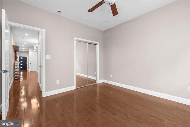 unfurnished bedroom featuring recessed lighting, wood finished floors, a ceiling fan, baseboards, and a closet