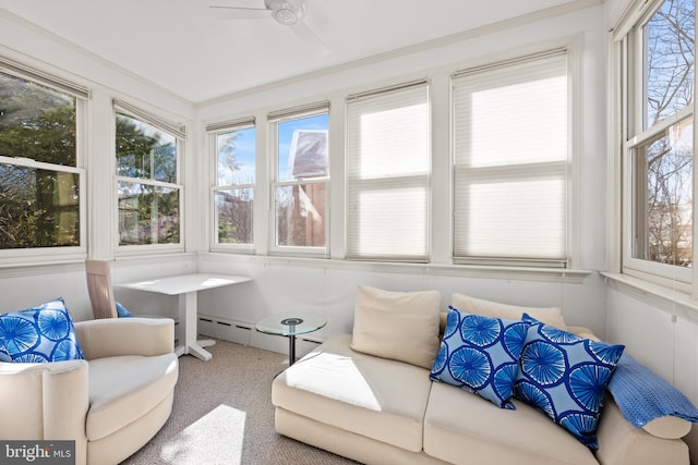 sunroom / solarium featuring a ceiling fan