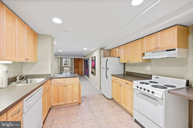 kitchen featuring under cabinet range hood, white appliances, a sink, and light brown cabinetry