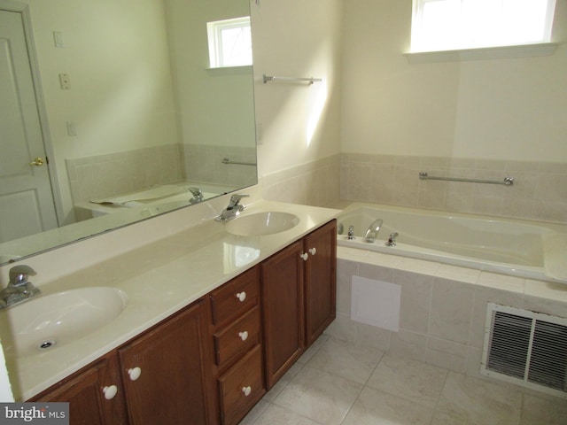 full bath featuring visible vents, a sink, a garden tub, and double vanity