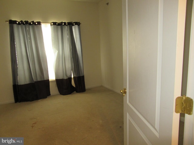 unfurnished room featuring carpet flooring