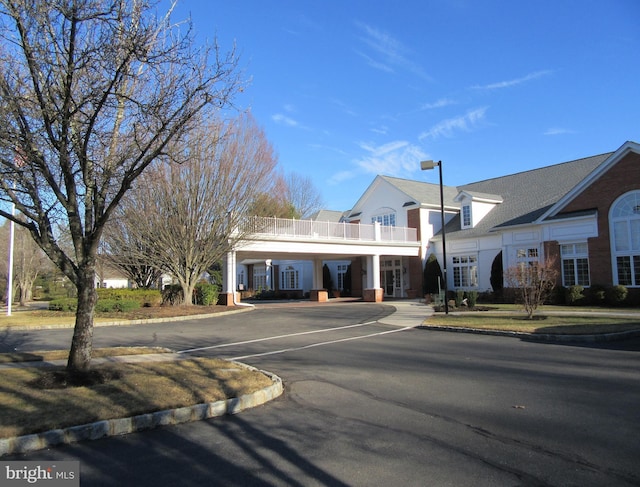 view of building exterior featuring uncovered parking