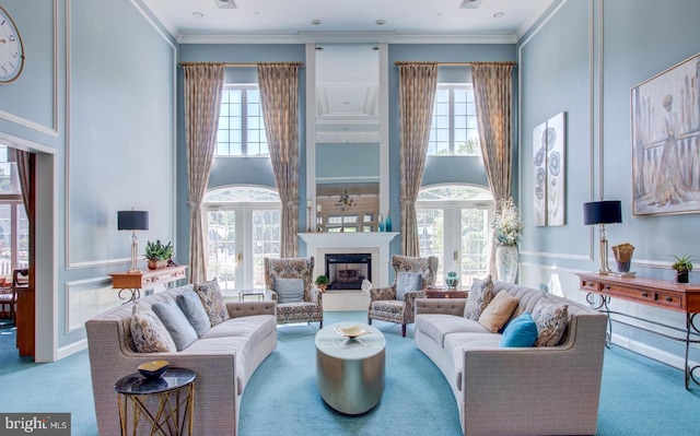 carpeted living room with ornamental molding, french doors, a wealth of natural light, and a high ceiling